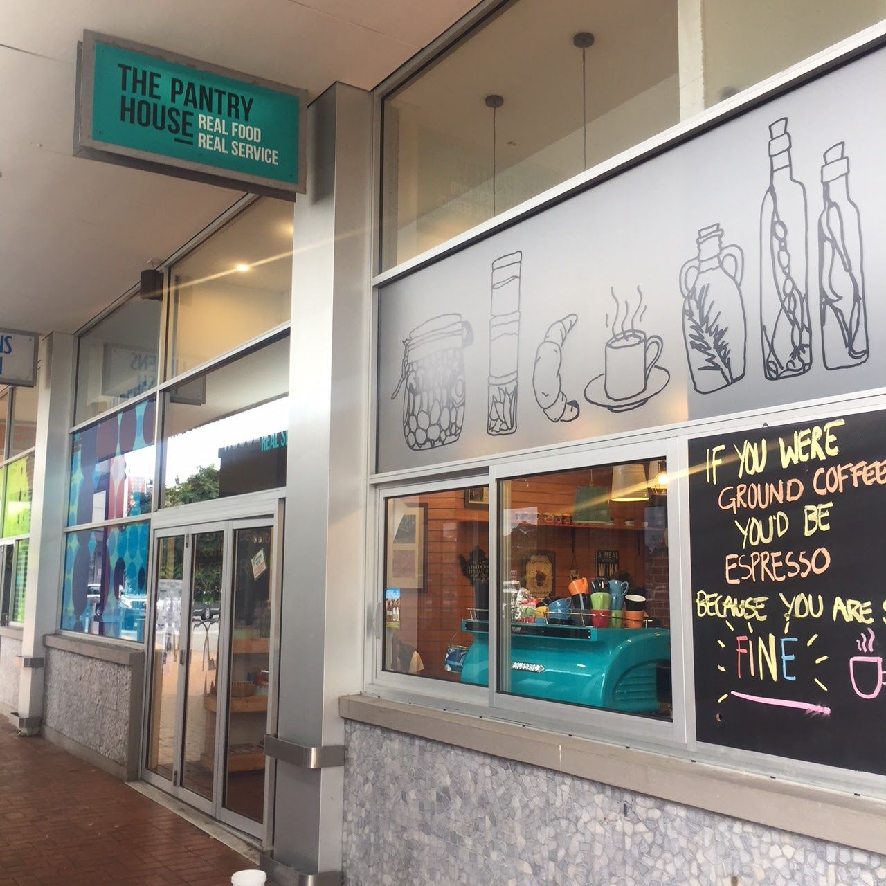 The Pantry House café storefront with illustrated window graphics and teal signage in Mornington